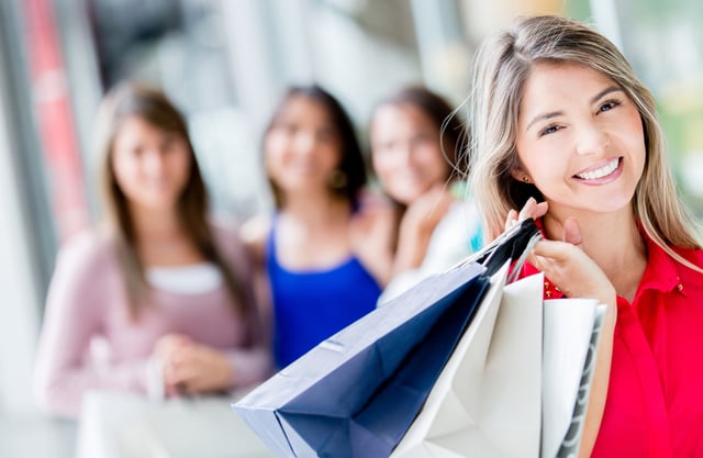 Shopping woman at the mall looking very happy