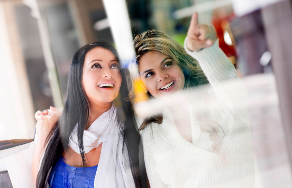 Beautiful friends window shopping at the mall