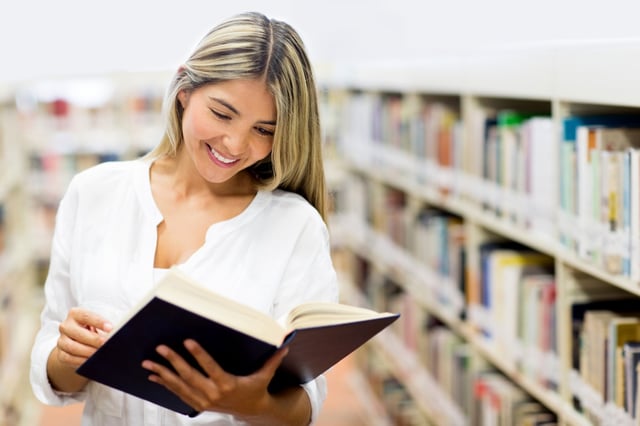 Beautiful woman at the library reading a book.jpeg