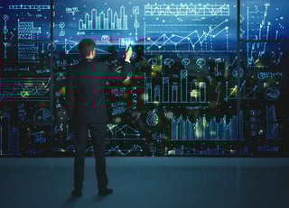 Businessman drawing business statistics on glass wall.jpeg
