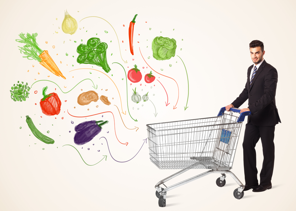 Businessman pushing a shopping cart and healthy vegetables coming out of it