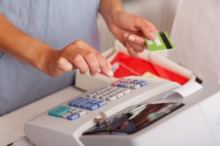 Midsection of saleswoman holding credit card while using ETR machine at boutique counter-1.jpeg