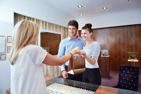 happy young romantic couple in love buy jewelry ring in luxury store