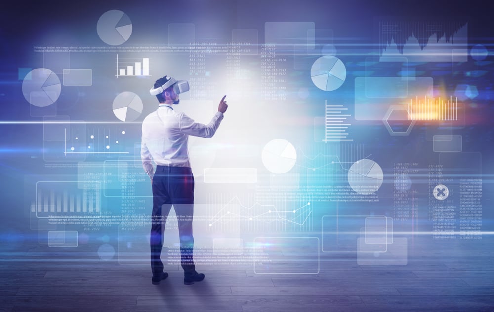 Good looking businessman checking reports and charts with vr glasses