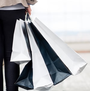 Woman holding shopping bags at the mall while walking